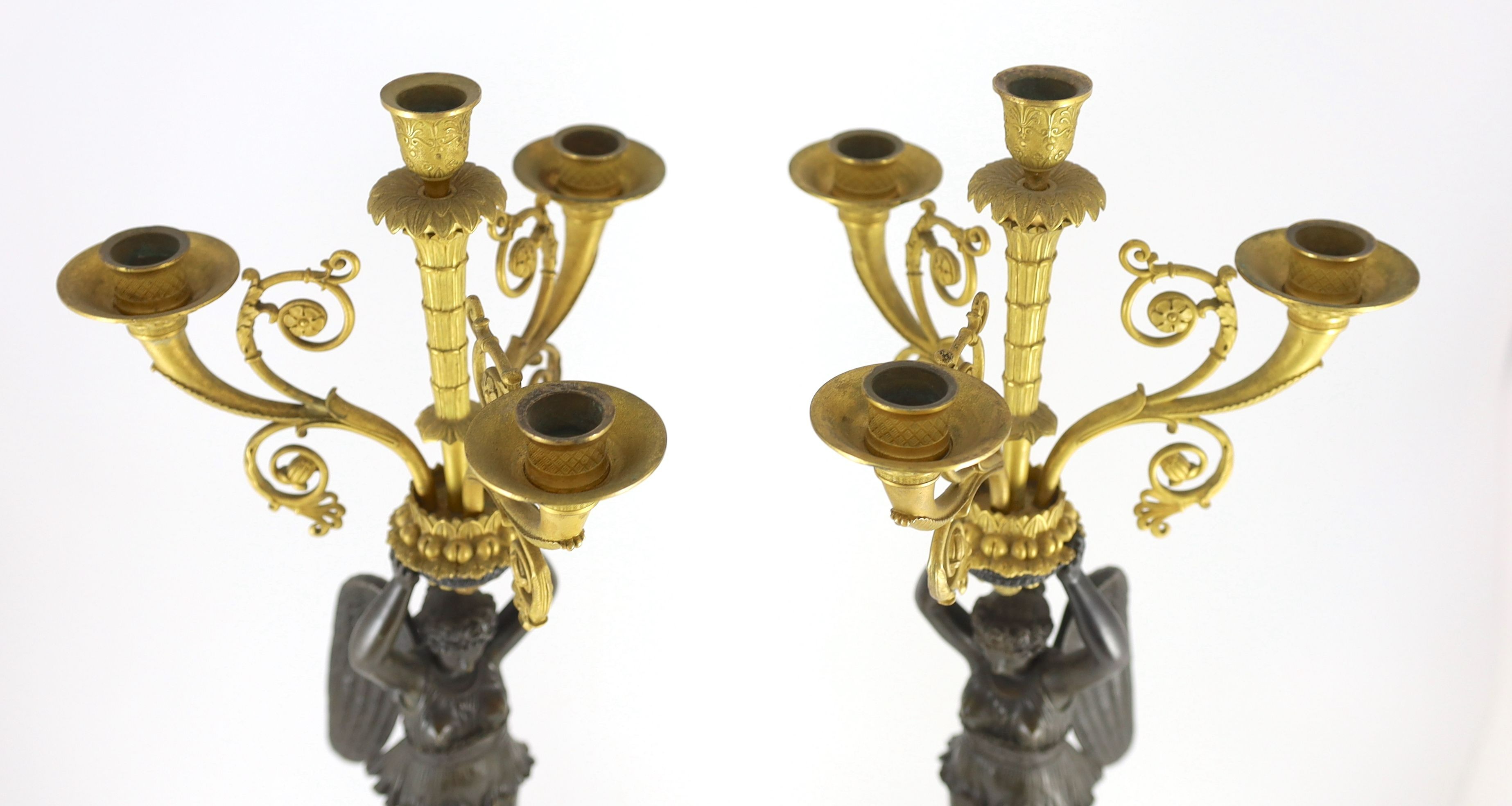 A pair of 19th century French Empire style bronze and ormolu four light candelabra, 21cm wide, 80cm high